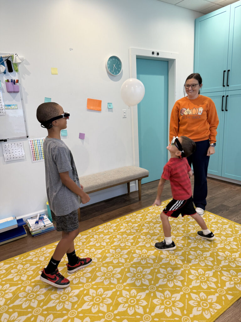 Children doing vision therapy balance exercises with a Navigation Eye Care therapist in Chesapeake VA