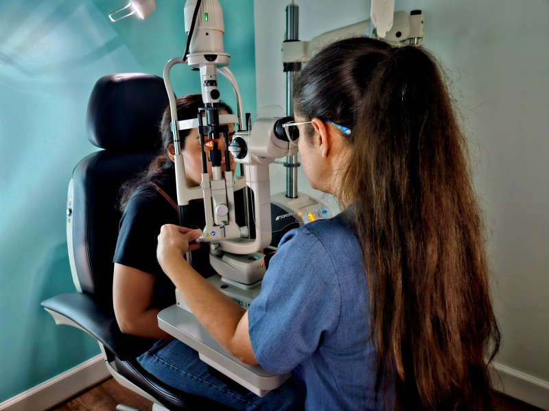 Dr. Amber Teten performing dry eye evaluation with slit lamp at Navigation Eye Care Chesapeake VA