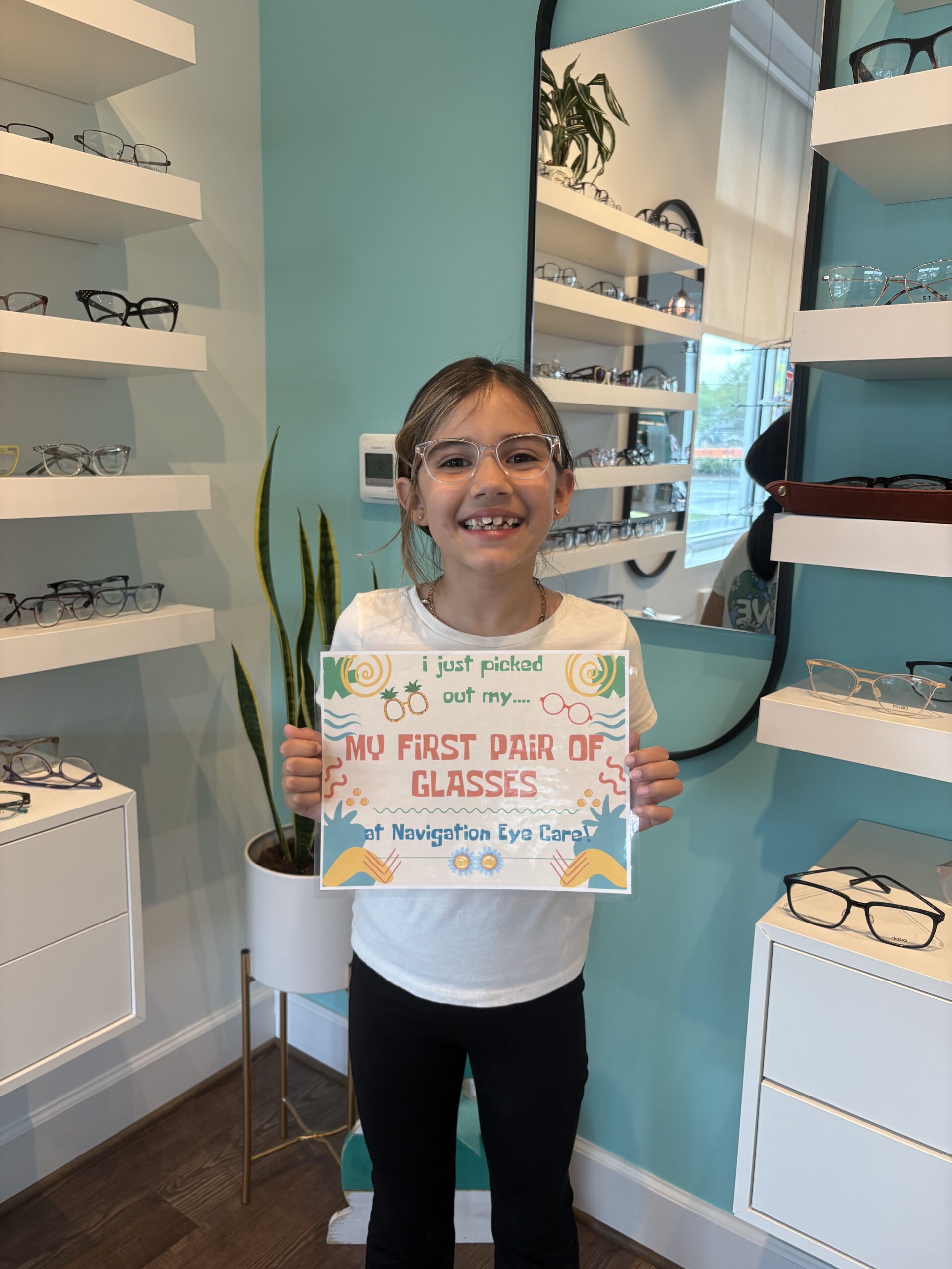 Child celebrating her 1st glasses and 1st eye exam
