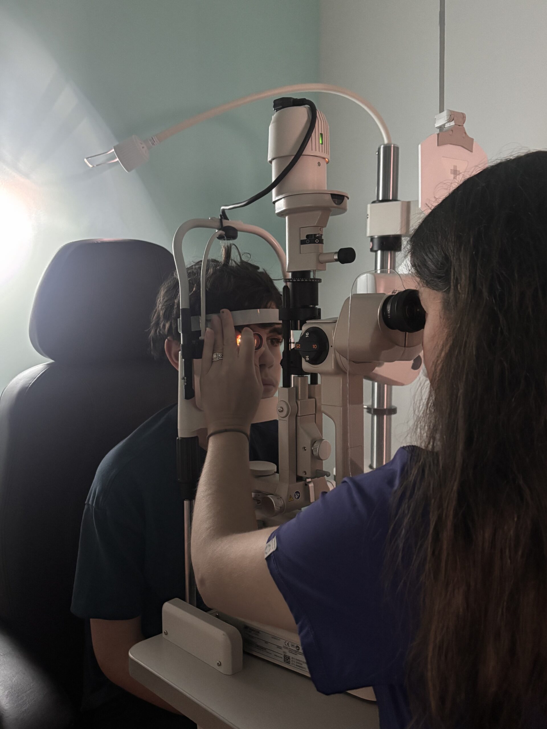 Eye doctor in Navigation Eye Care seen doing an eye exam for children’s vision screening