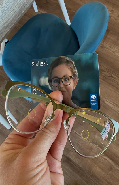 Essilor Stellest spectacle lens for myopia control held up showing H.A.L.T. lenslet technology Navigation Eye Care Chesapeake VA