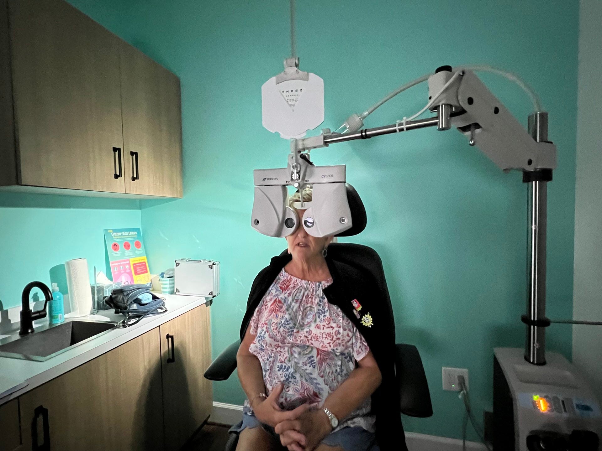 Patient receiving comprehensive eye exam with phoropter at Navigation Eye Care Chesapeake VA