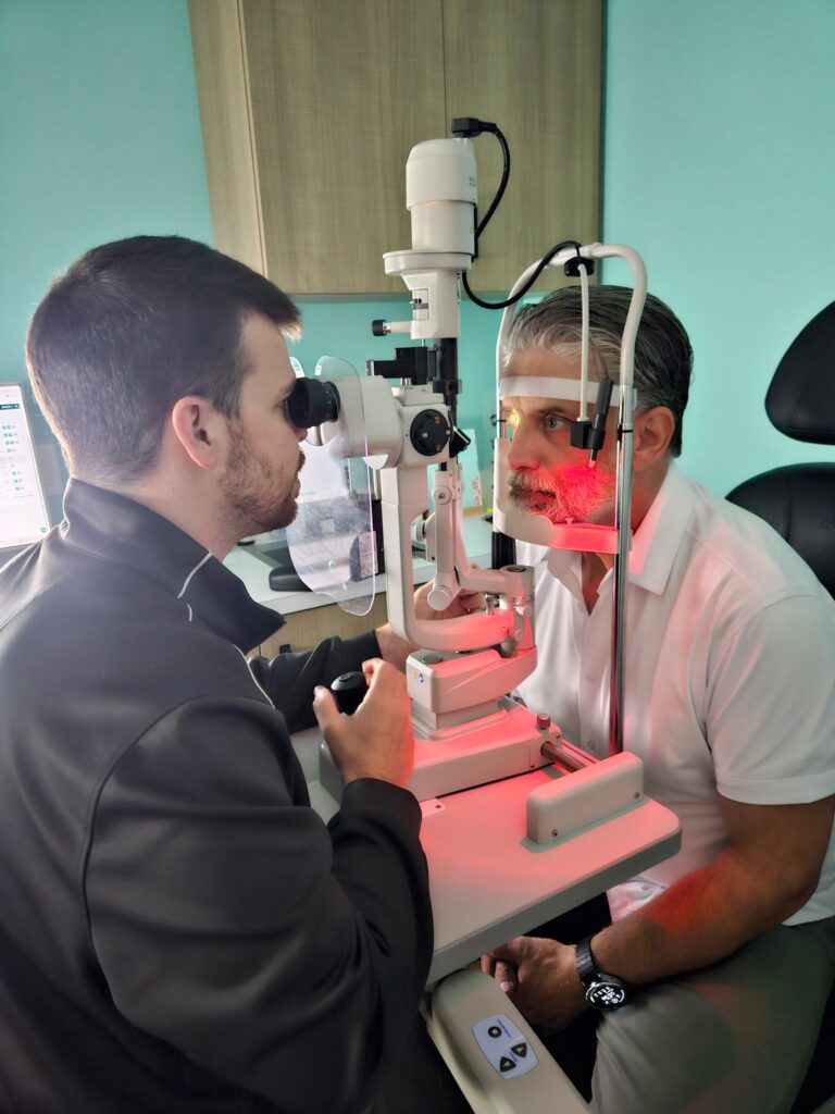 Dr. Moss examines a patient's eye using a slit lamp at Navigation Eye Care.