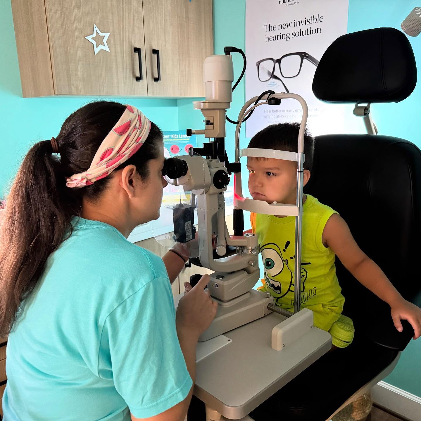 Dr. Teten performing a slit lamp eye exam on a young toddler at Navigation Eye Care Chesapeake VA