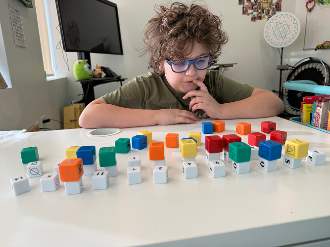 Child concentrating on learning activity at home showing impact of vision problems on development Chesapeake VA