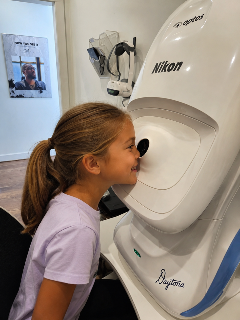 Young girl receiving Optomap retinal imaging at Navigation Eye Care Chesapeake VA eye exam