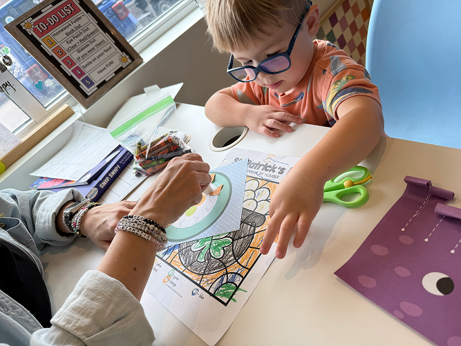 Child completing vision therapy activity with Navigation Eye Care team member Chesapeake VA