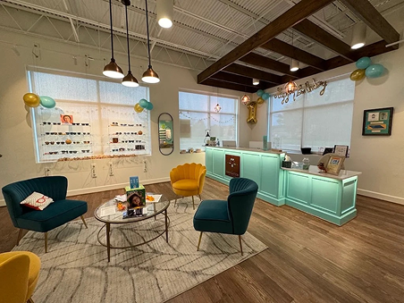 Welcoming reception and waiting area at Navigation Eye Care Chesapeake VA with modern decor and optical display