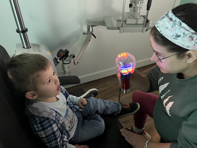 Dr. Teten performing pediatric eye exam on young child Navigation Eye Care Chesapeake VA